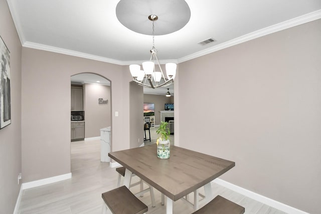 18306 Fresh Air Ct, Houston, TX 77084 - dining area featuring visible vents, arched walkways, crown molding, and a notable chandelier