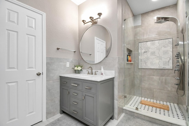18306 Fresh Air Ct, Houston, TX 77084 - full bath featuring vanity, a tile shower, and tile walls