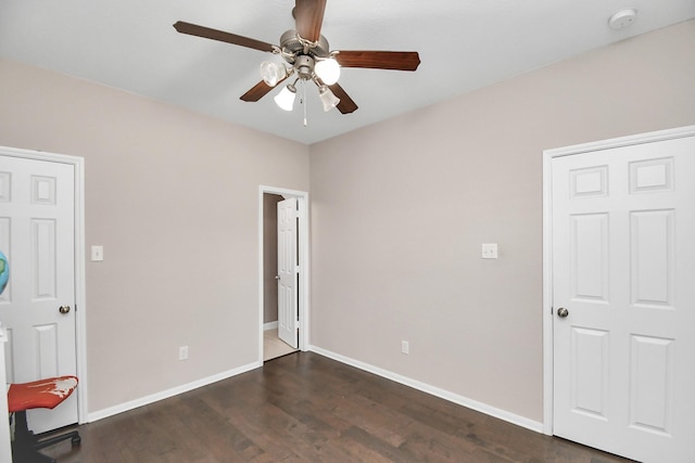 18306 Fresh Air Ct, Houston, TX 77084 - unfurnished bedroom with dark wood-style flooring, baseboards, and a ceiling fan