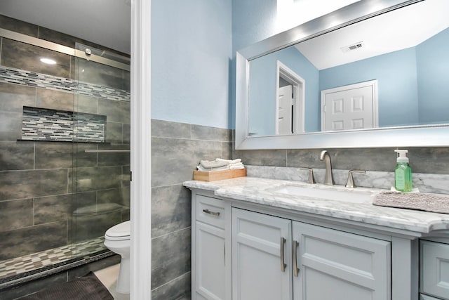 18306 Fresh Air Ct, Houston, TX 77084 - full bathroom featuring vanity, tile walls, a shower stall, and toilet
