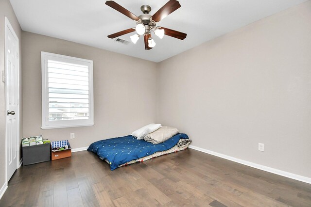 18306 Fresh Air Ct, Houston, TX 77084 - bedroom with baseboards, ceiling fan, wood finished floors, and visible vents