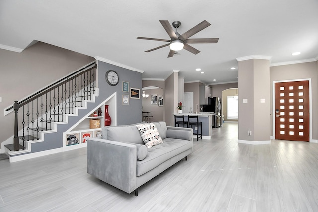 18306 Fresh Air Ct, Houston, TX 77084 - living area with ceiling fan, crown molding, arched walkways, stairway, and recessed lighting