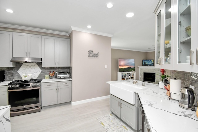 18306 Fresh Air Ct, Houston, TX 77084 - kitchen featuring under cabinet range hood, gray cabinets, a sink, and stainless steel gas range oven