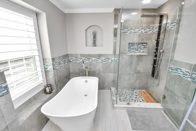 18306 Fresh Air Ct, Houston, TX 77084 - full bathroom with a freestanding tub, tile walls, a healthy amount of sunlight, and a stall shower
