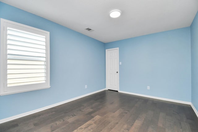 18306 Fresh Air Ct, Houston, TX 77084 - unfurnished room featuring baseboards, dark wood-type flooring, and visible vents