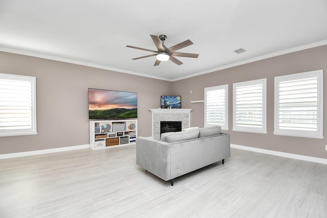 18306 Fresh Air Ct, Houston, TX 77084 - living room featuring a ceiling fan, visible vents, baseboards, ornamental molding, and light wood-style flooring