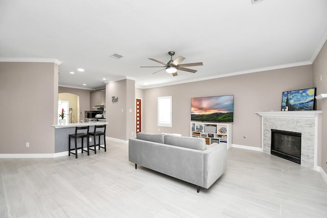 18306 Fresh Air Ct, Houston, TX 77084 - living room featuring visible vents, ornamental molding, a fireplace, baseboards, and a ceiling fan