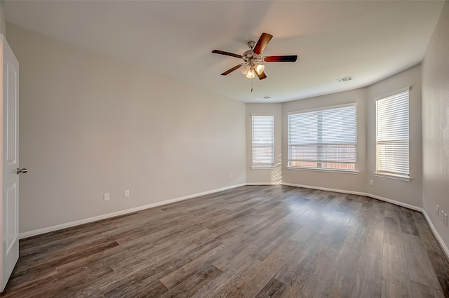 unfurnished room featuring dark wood-type flooring and ceiling fan