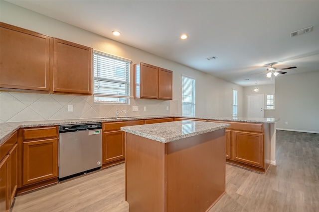 kitchen with ceiling fan, dishwasher, light hardwood / wood-style floors, and a kitchen island