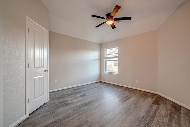 unfurnished room featuring ceiling fan and dark hardwood / wood-style floors