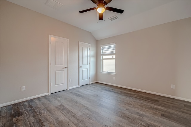 spare room featuring dark wood-type flooring, ceiling fan, and lofted ceiling