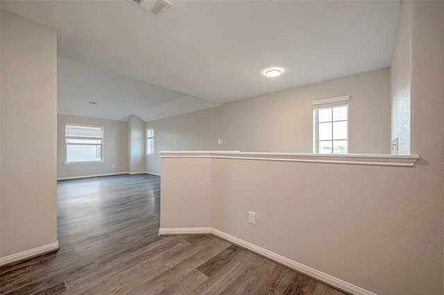 spare room featuring a wealth of natural light and wood-type flooring