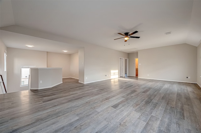 interior space with lofted ceiling, hardwood / wood-style floors, and ceiling fan