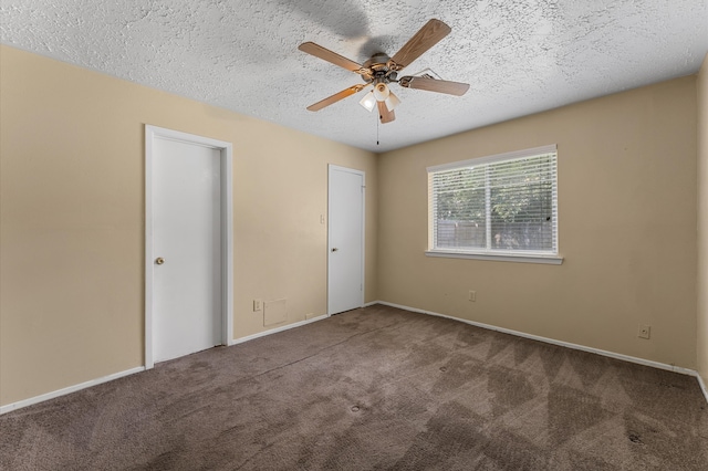 unfurnished bedroom featuring a textured ceiling, carpet, and ceiling fan