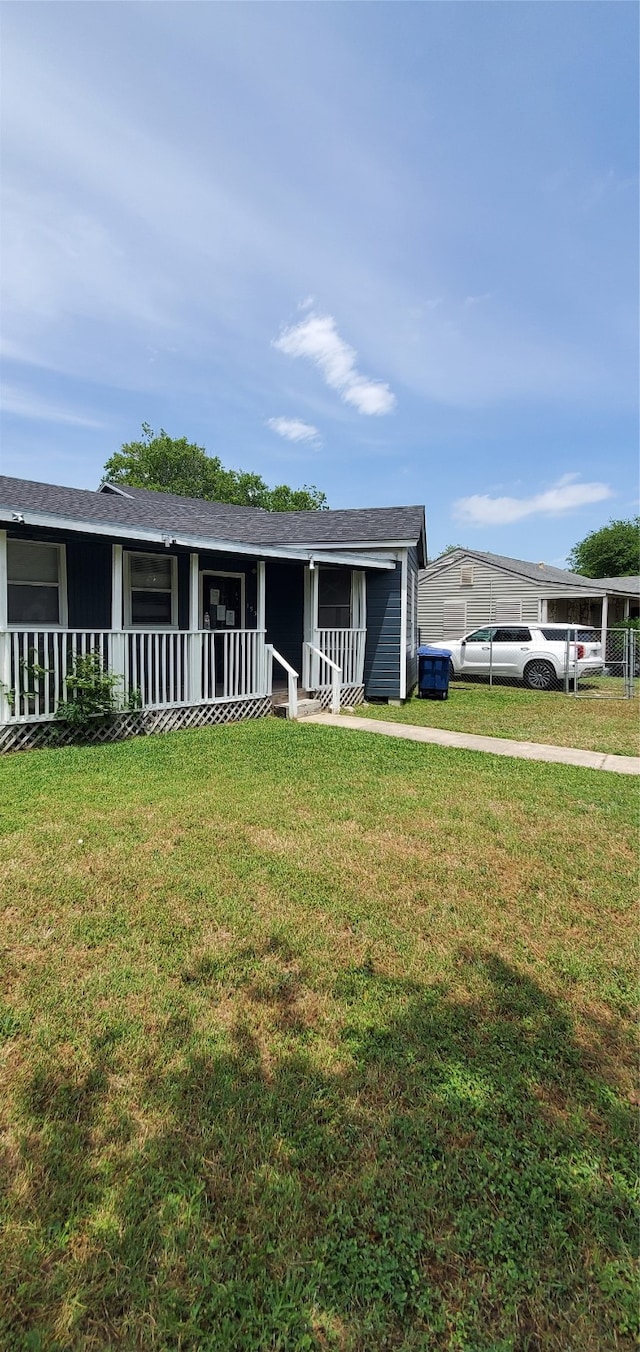 single story home with a front yard, a porch, and a carport