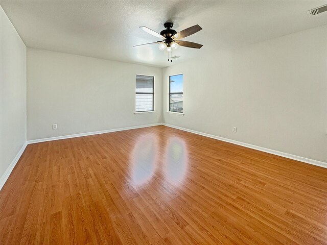 spare room with light hardwood / wood-style flooring and ceiling fan