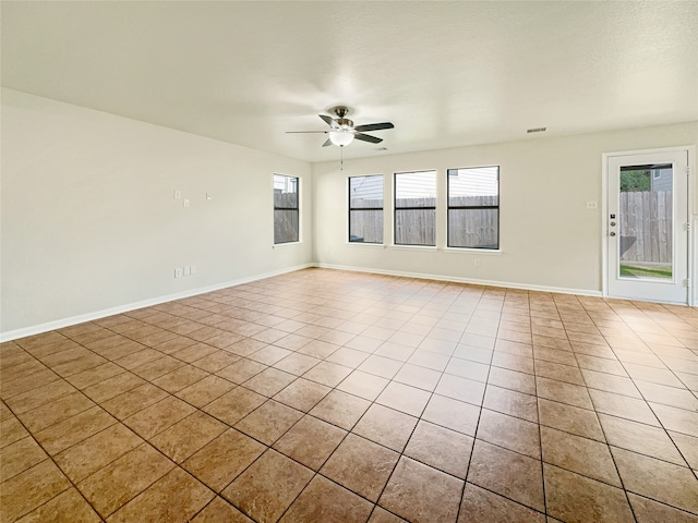 empty room featuring ceiling fan and light tile patterned flooring