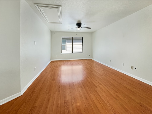 unfurnished room with a textured ceiling, hardwood / wood-style flooring, and ceiling fan