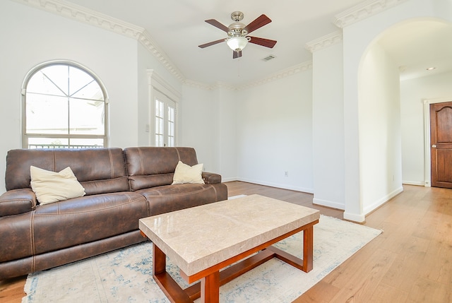 living room featuring ornamental molding, ceiling fan, and light hardwood / wood-style floors