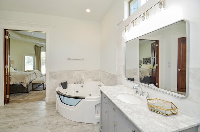 bathroom featuring a tub to relax in and vanity