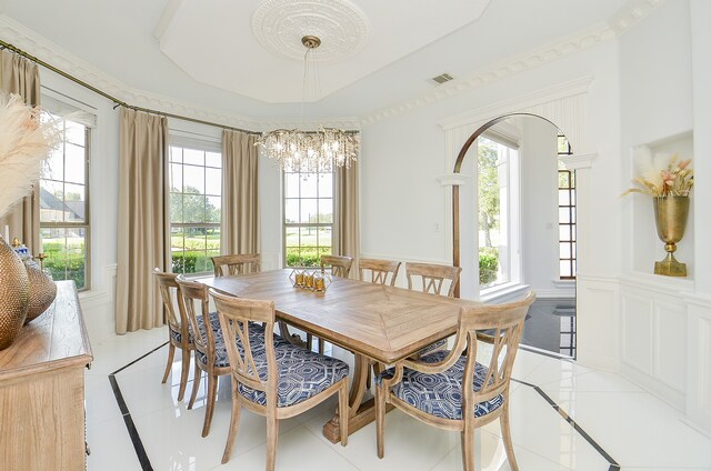 dining area with a chandelier and light tile patterned flooring