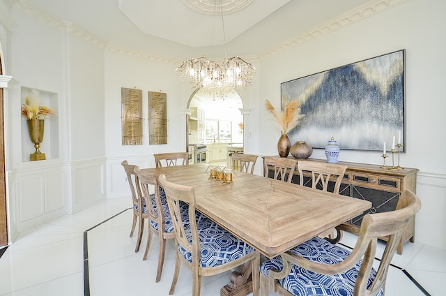 tiled dining room featuring an inviting chandelier