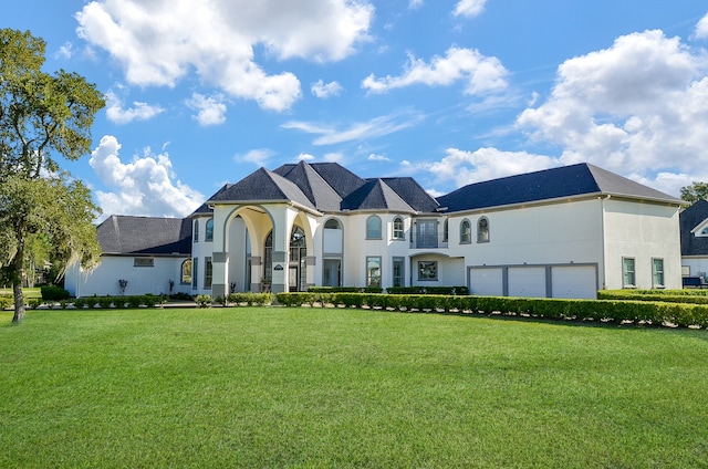 view of front of property with a front lawn and a garage