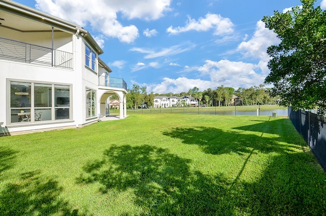 view of yard with a balcony