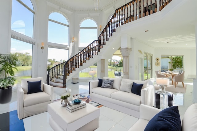 tiled living room with ornamental molding, plenty of natural light, and a towering ceiling