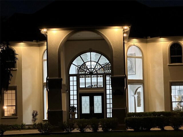 view of exterior entry at night