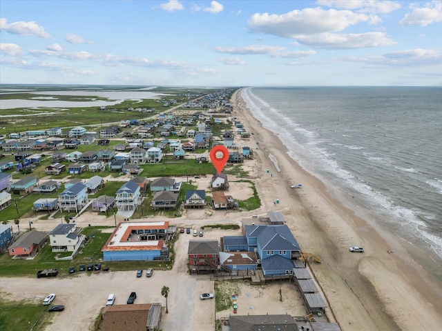 drone / aerial view featuring a view of the beach and a water view