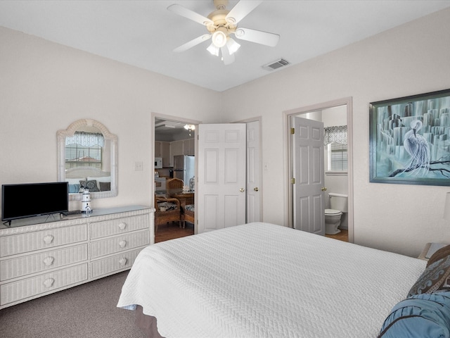 125 Driftwood Ct, Surfside Beach, TX 77541 - bedroom with freestanding refrigerator, a ceiling fan, visible vents, and ensuite bath