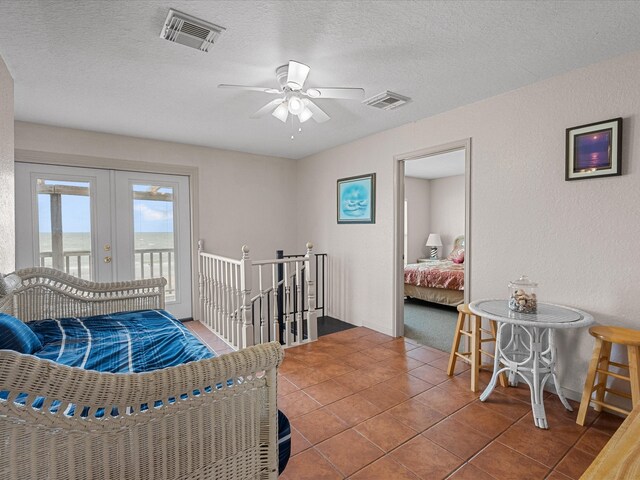 interior space featuring access to outside, french doors, tile patterned floors, a textured ceiling, and ceiling fan