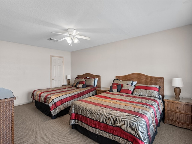 bedroom with ceiling fan, a textured ceiling, and light carpet