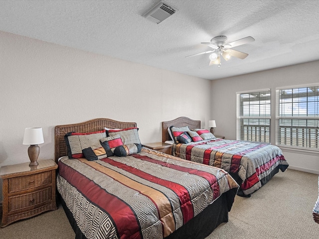 125 Driftwood Ct, Surfside Beach, TX 77541 - bedroom with carpet, a ceiling fan, a textured ceiling, and visible vents
