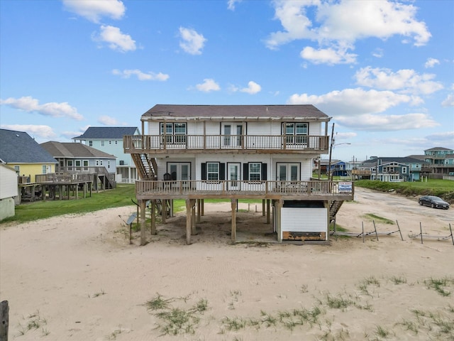 125 Driftwood Ct, Surfside Beach, TX 77541 - back of property featuring a wooden deck, french doors, dirt driveway, stairway, and a carport