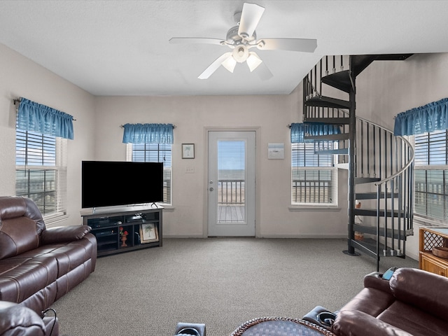 living room featuring a wealth of natural light, carpet, and ceiling fan