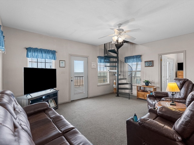 living room featuring carpet, ceiling fan, and plenty of natural light