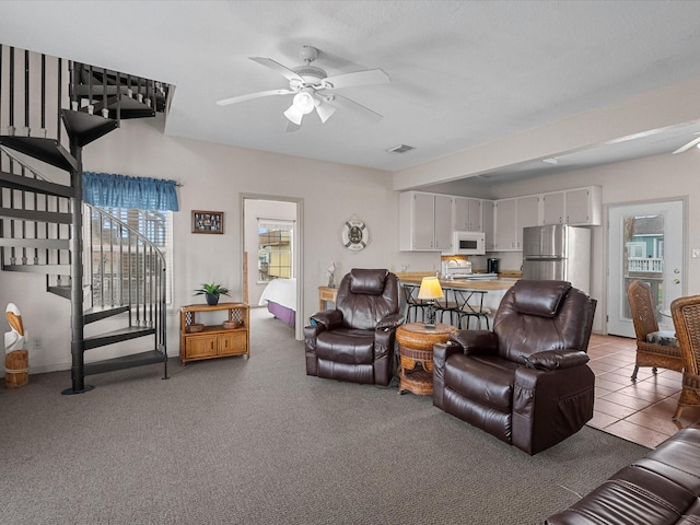 125 Driftwood Ct, Surfside Beach, TX 77541 - carpeted living room featuring visible vents, ceiling fan, and stairway