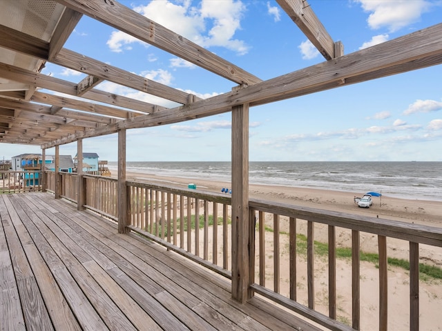 deck with a view of the beach and a water view