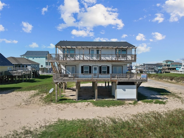 125 Driftwood Ct, Surfside Beach, TX 77541 - rear view of house with a wooden deck and stairway