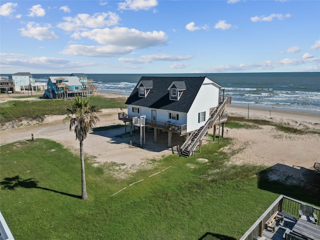 drone / aerial view featuring a view of the beach and a water view