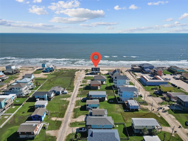 drone / aerial view featuring a beach view and a water view