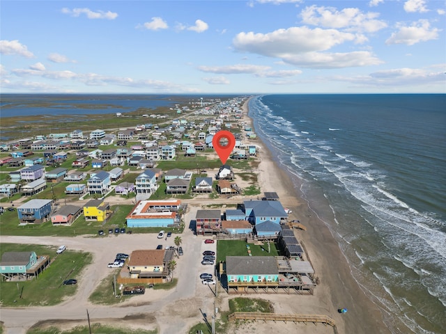 birds eye view of property with a beach view and a water view