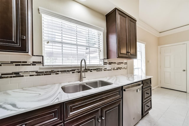 kitchen with backsplash, dark brown cabinets, ornamental molding, stainless steel dishwasher, and a sink