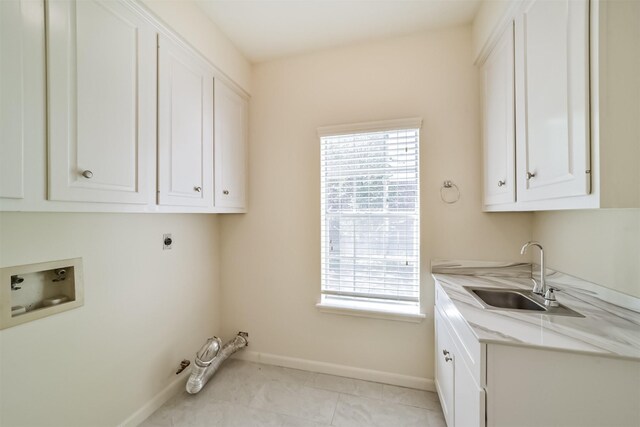 laundry room with baseboards, cabinet space, electric dryer hookup, washer hookup, and a sink