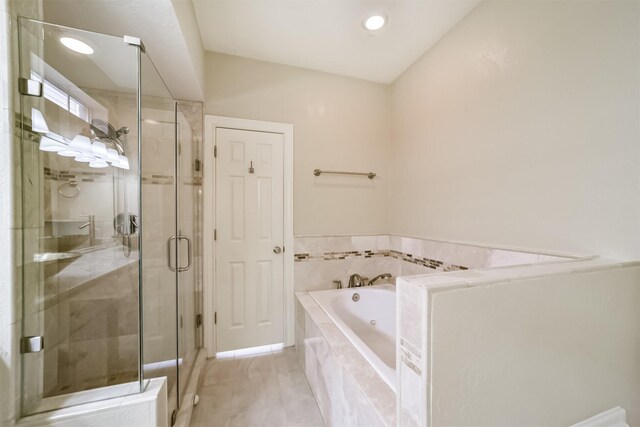 bathroom with a garden tub and a shower stall