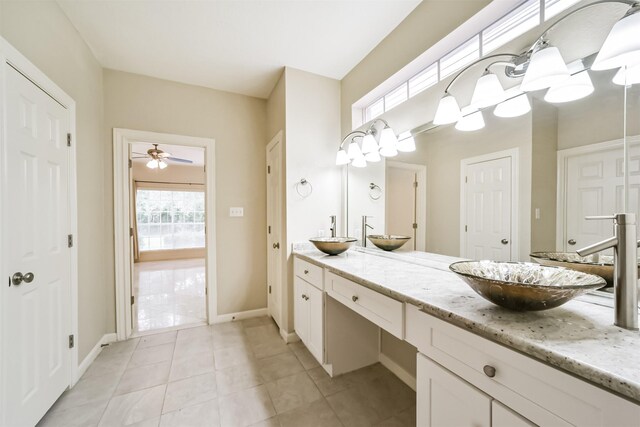 full bath with double vanity, tile patterned floors, and a sink