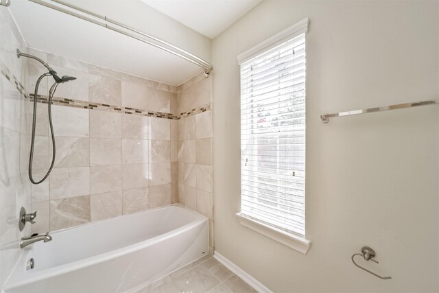 bathroom with tile patterned flooring,  shower combination, and baseboards