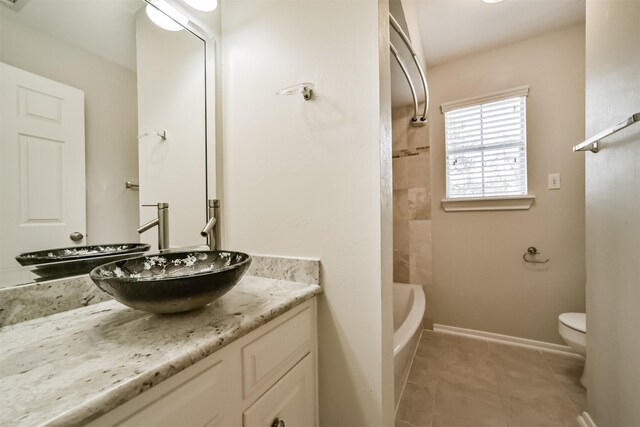 full bath featuring tile patterned flooring, toilet, vanity, and baseboards